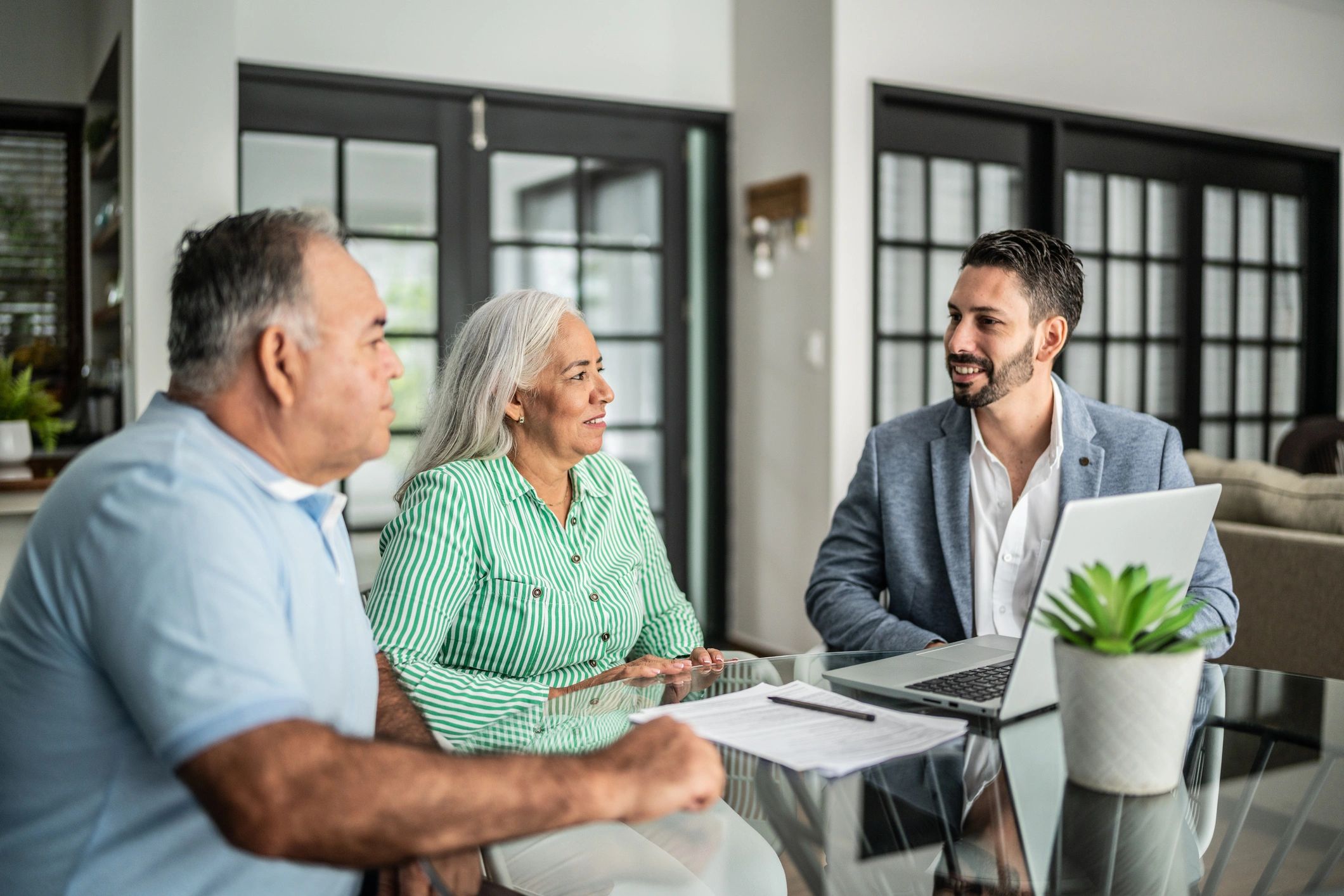 Attorneys meeting with a senior couple about timeshare cancellation